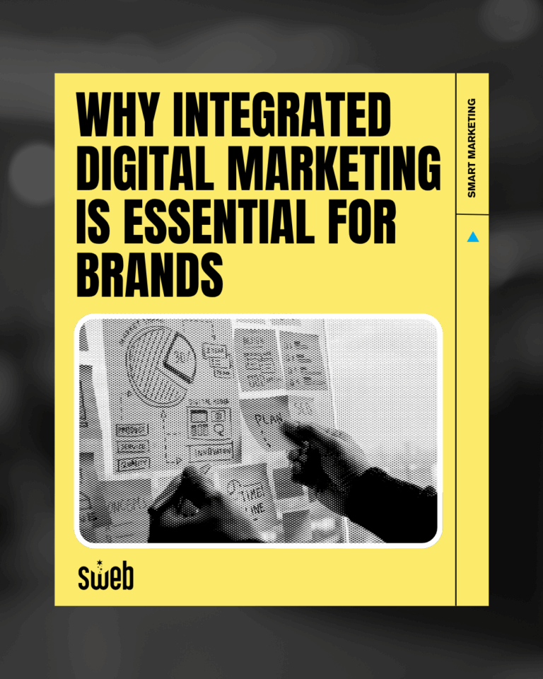 Hands creating a digital marketing plan with charts and notes, symbolizing integrated brand strategy